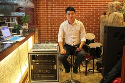 Portrait music shop owner Lin Fangxi “明星琴行”店主林方喜. Photograph: team leader of (...)