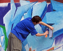  <p>A graffiti artist at work in Bucharest, Romania, painting a wall on Str. Arthur Verona. Image by Bogdan, 2006</p>